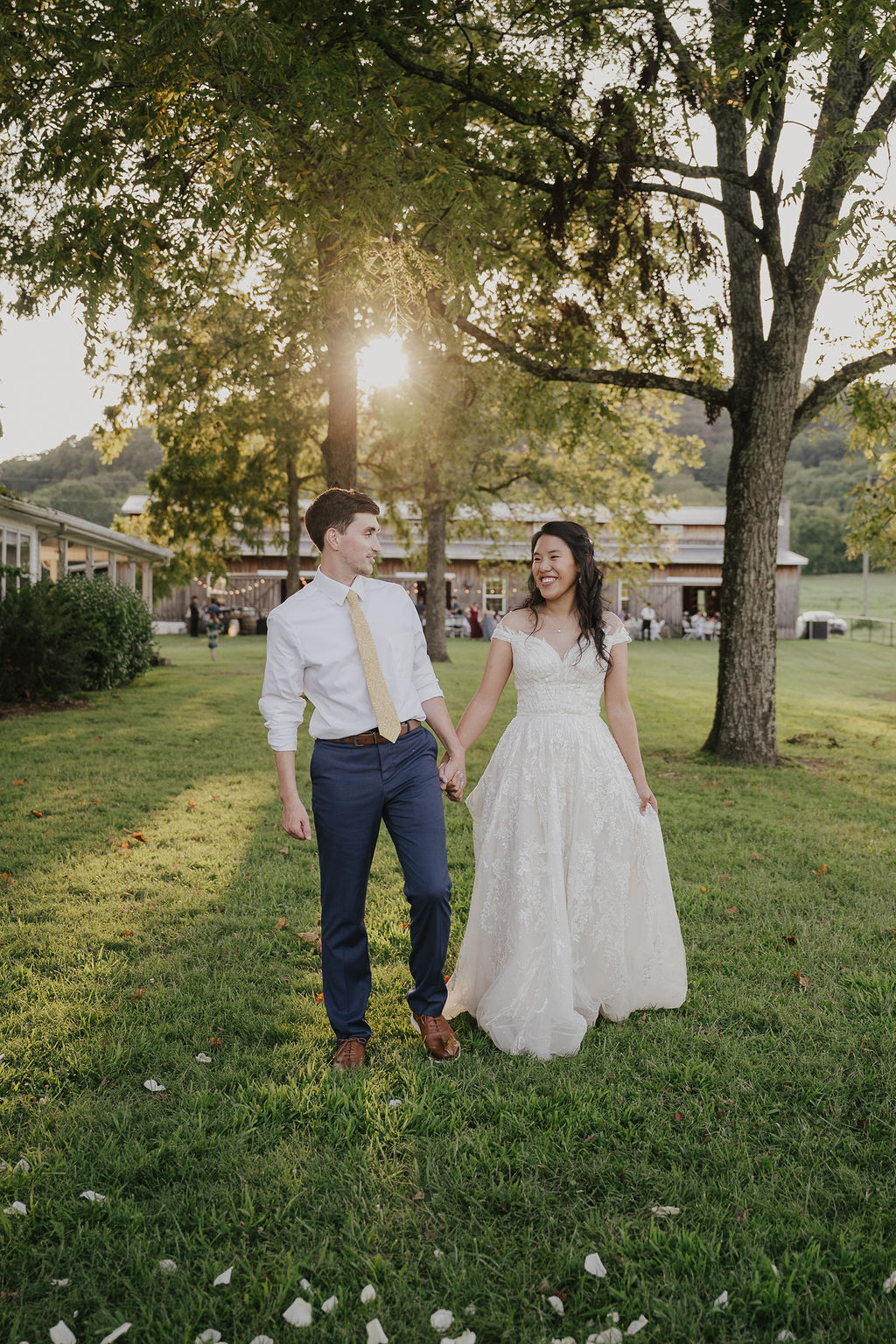 Bride and groom take newlywed portraits at sunset.