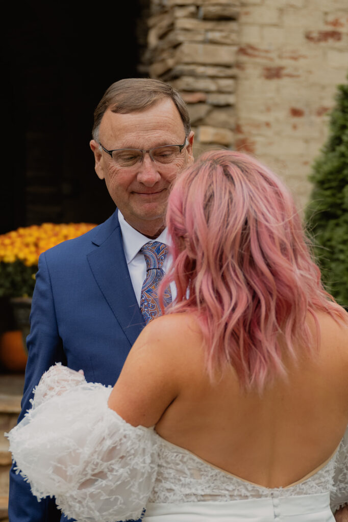 The bride shares a first look moment with the father of the bride.